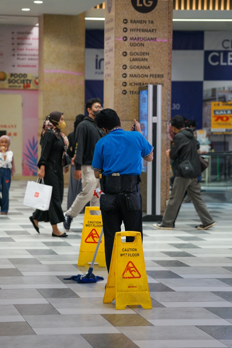 A group of people walking around a shopping mall